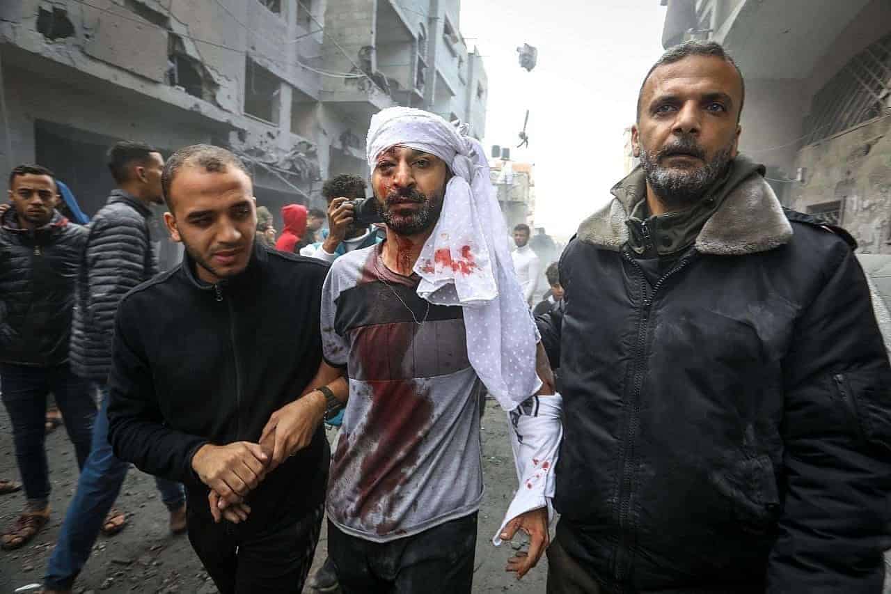 Palestinians emerge from the rubble of houses destroyed in israeli airstrikes in the city of rafah