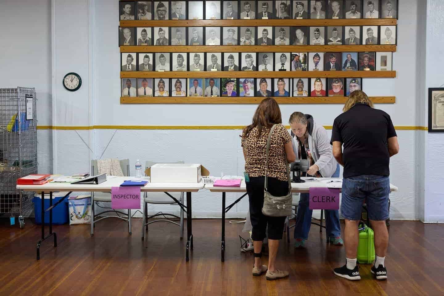 Poll worker bonnie anguiano (center) assists voters at a polling station at the american legion hall in shasta lake, california, during a special election in shasta county nov. 7, 2023.