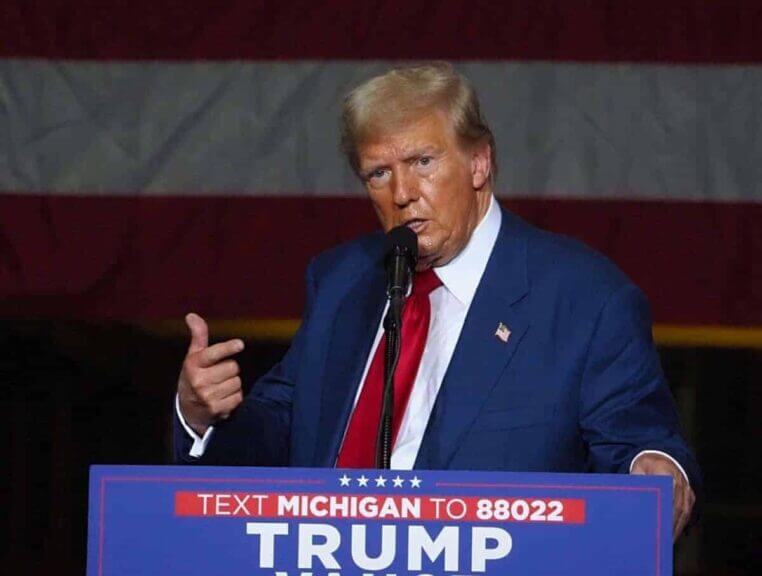 Trump on stage at a rally in michigan
