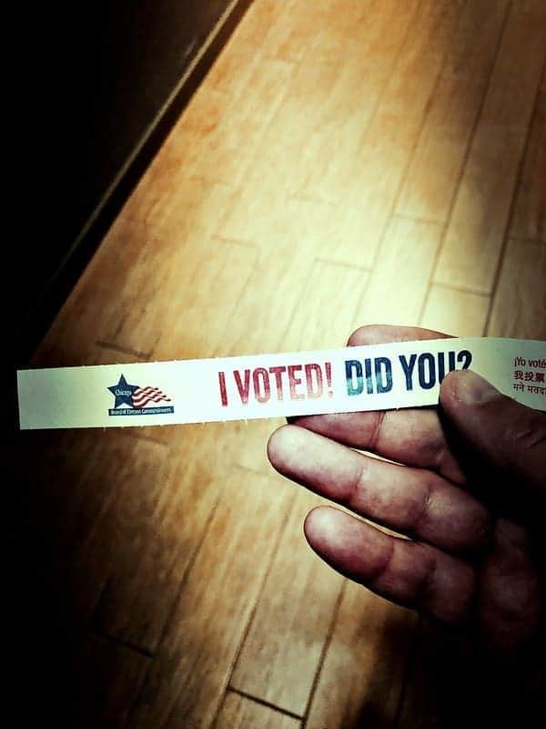 Hand holding a sticker that says, i voted. Did you?