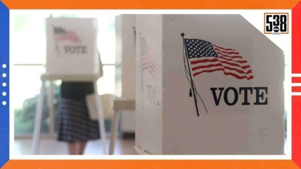 People voting in cardboard cubicles