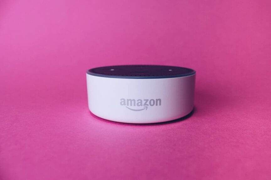 Amazon alexa dot device surrounded by the color pink