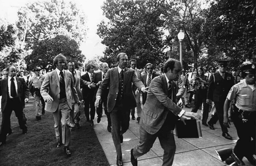 Following the september 5, 1975 10:04 am[1] attempt on u. S. President gerald ford's life by cultist charles manson family member lynette "squeaky" fromme, secret service agents rush president ford towards the california state capitol in sacramento.