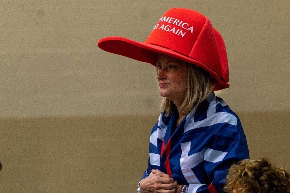 What Maga Means To Americans Maga woman wearing an oversized red maga hat in florid