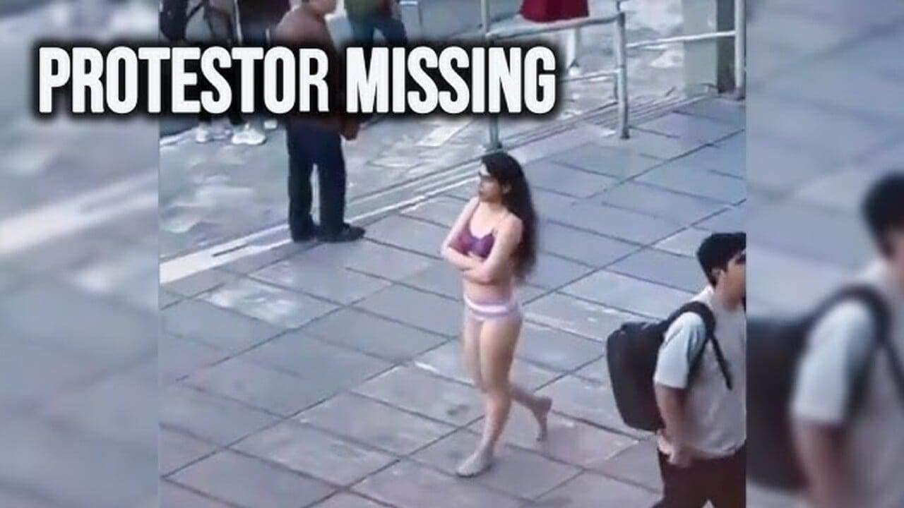 Woman walking down the street in her bra and underwear in protest in iran