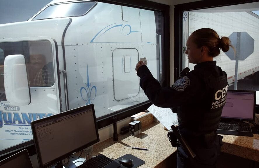 A u. S. Customs and border protection officer checks the identification of truck driver as he passes through the u. S. Checkpoint of the cargo pre-inspection at the otay mesa, calif. , port of entry, june 22, 2016. On any given day, several hundred trucks line up on the mexican side of the border to deliver imports ultimately awaiting the process of screening by customs officers.