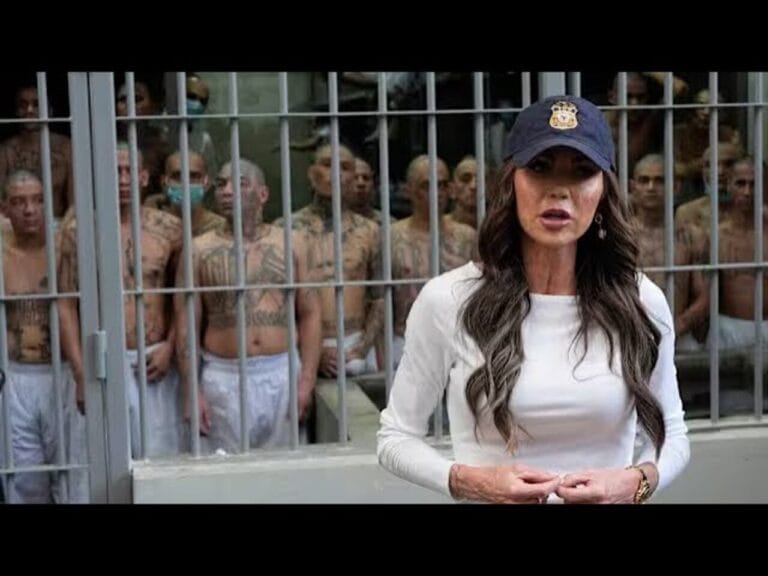 Dhs secretary kristi noem standing in front of a cell full of prisoners in el salvador