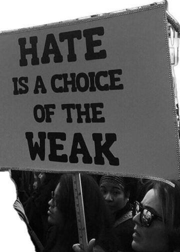 Protest sign that says hate is a choice of the weak. It’s