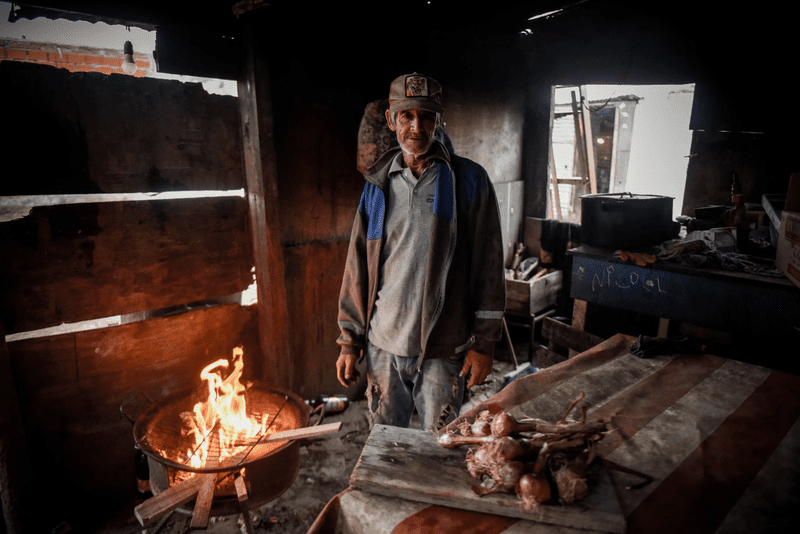 Man burning wood to cook in his home in argentina