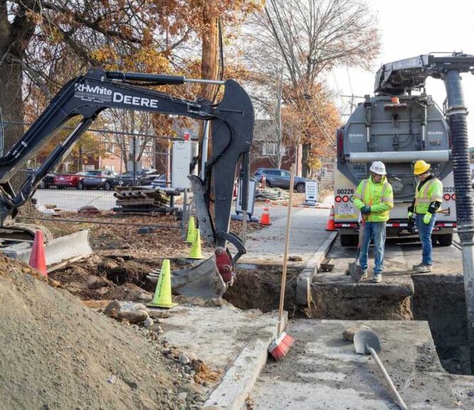 Men in hard hats working on geothermal energy infrastructure.
