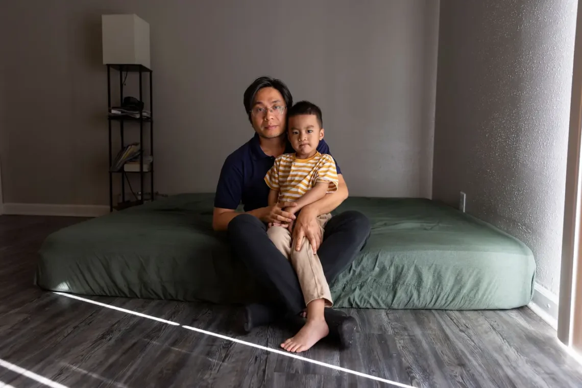 A Texas Boy Needed Protection From Measles. The Vaccine Cost $1,400. Texas boy sitting in the lap of his father