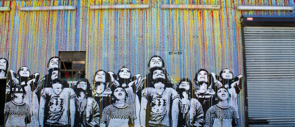 Art on a fence of children looking up