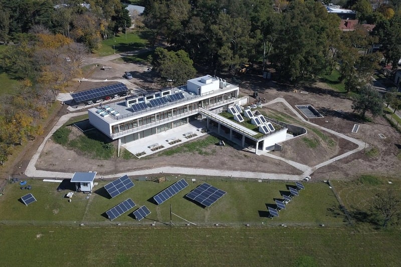Aerial view of a large building with solar panels on the roof.
