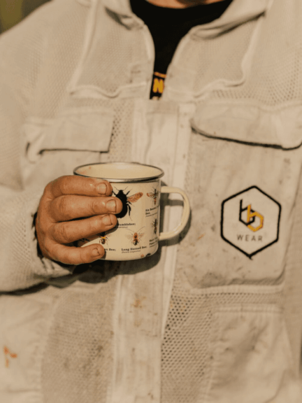 The Woman Who Rescues Bees: From Doomed Swarm To Thriving Hive Woman who rescues bees holding a branded coffee mug